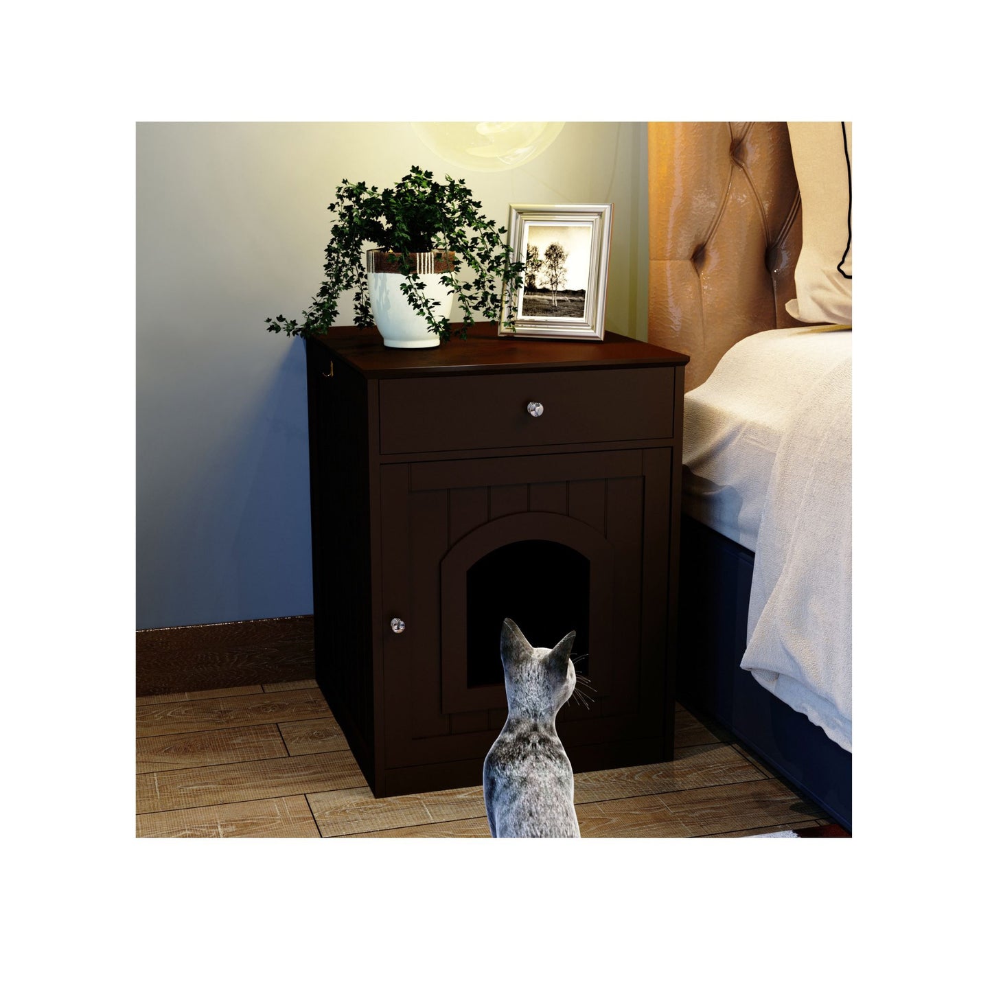 Dark wooden pet door in a nightstand next to a bed with a cat looking at it.