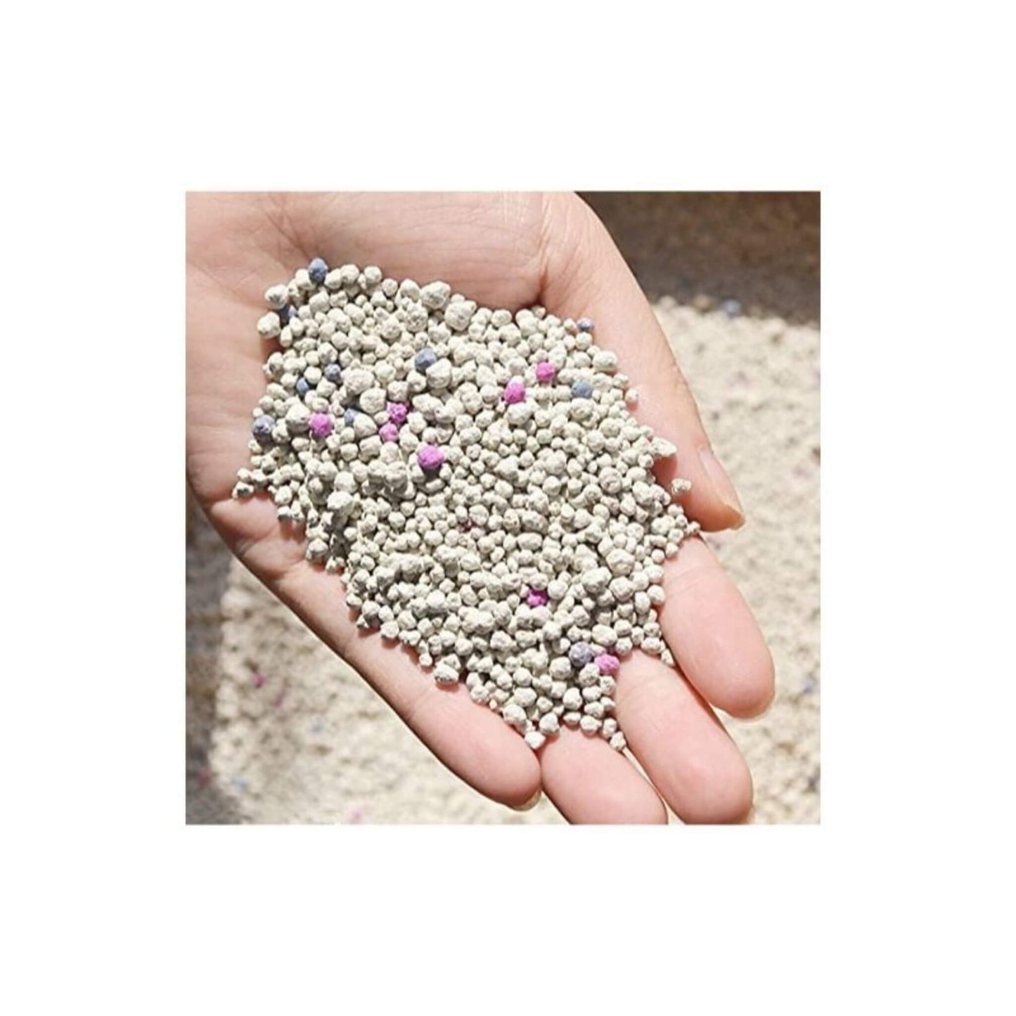 Hand holding small, multicolored granules against a neutral background