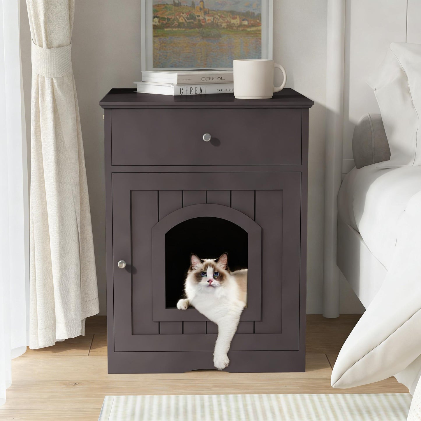 Cat peeking out from a dark wooden pet door in a nightstand next to a bed.