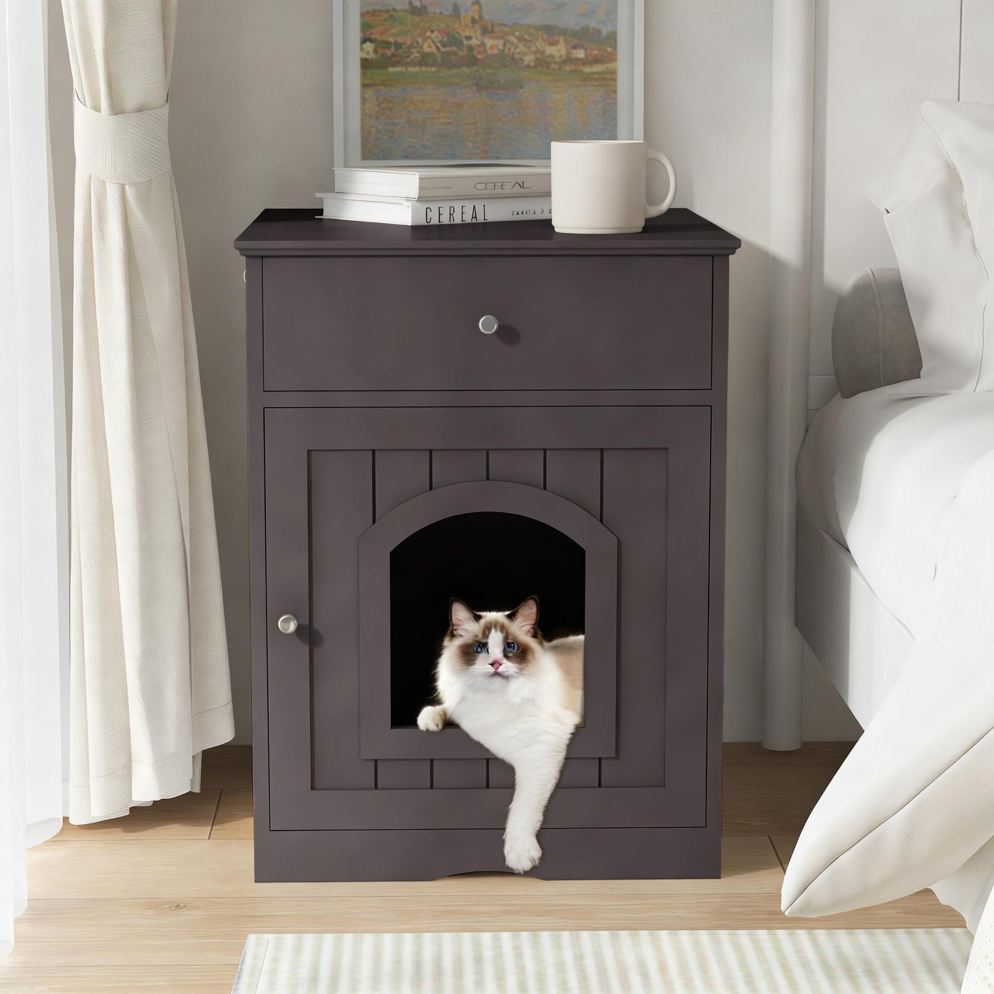 Cat peeking out from a dark wooden pet door in a nightstand next to a bed.